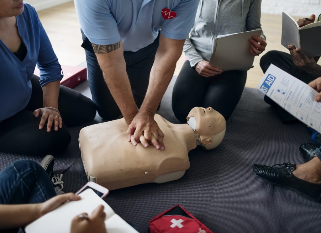 Students practicing chest compressions on a mannequin during a CPR course CPR refreshers course